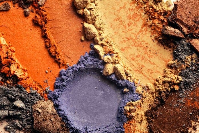 Orange, tan and purple pigment powders used in polymer additives.